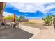 A well maintained backyard with green grass, decorative gravel, and a covered patio perfect for outdoor living at 30587 N Maple Chase Dr, San Tan Valley, AZ 85143