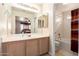 Well-lit bathroom with double mirrors, spacious vanity, and a shower-tub combination with a curtain at 30587 N Maple Chase Dr, San Tan Valley, AZ 85143