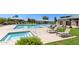 A large community pool and spa area, surrounded by lounge chairs and shaded gazebos at 30587 N Maple Chase Dr, San Tan Valley, AZ 85143