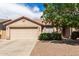 Charming single-story home with a two-car garage and low-maintenance landscaping, situated under a vibrant blue sky at 30587 N Maple Chase Dr, San Tan Valley, AZ 85143