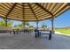 Covered gazebo with picnic tables, a great spot for outdoor dining and community gatherings with views of the lake at 30587 N Maple Chase Dr, San Tan Valley, AZ 85143