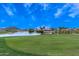 Scenic golf course with a water hazard and lush green fairways, offering a challenging and picturesque experience at 30587 N Maple Chase Dr, San Tan Valley, AZ 85143