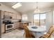 Bright eat-in kitchen features stainless steel appliances and a sliding glass door to access the yard at 30587 N Maple Chase Dr, San Tan Valley, AZ 85143