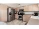This kitchen features stainless steel appliances, light colored cabinets, and practical design elements at 30587 N Maple Chase Dr, San Tan Valley, AZ 85143
