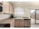 Bright kitchen featuring stainless steel appliances, neutral countertops, and a sliding glass door to the backyard at 30587 N Maple Chase Dr, San Tan Valley, AZ 85143