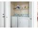 Laundry room with a washer and dryer, shelving for supplies, and a clean, organized space at 30587 N Maple Chase Dr, San Tan Valley, AZ 85143