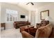 Inviting living room featuring vaulted ceilings, plantation shutters, and comfortable upholstered sofas at 30587 N Maple Chase Dr, San Tan Valley, AZ 85143