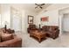 Cozy living room with neutral carpet, a ceiling fan, a high ceiling and comfortable seating arrangements at 30587 N Maple Chase Dr, San Tan Valley, AZ 85143