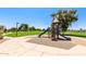 A colorful playground with slides and climbing structures, set in a grassy park with walking trails at 30587 N Maple Chase Dr, San Tan Valley, AZ 85143