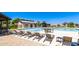 Community pool area with lounge chairs and umbrellas, perfect for relaxation and recreation on sunny days at 30587 N Maple Chase Dr, San Tan Valley, AZ 85143