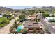 Backyard view of a single-story home with a pool, patio, and lush landscaping with mountains in the distance at 3131 E Las Rocas Dr, Phoenix, AZ 85028