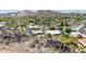 Stunning aerial view of a desert community with lush landscaping, sparkling pools, and mountain views at 3131 E Las Rocas Dr, Phoenix, AZ 85028