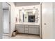 Bathroom featuring a double vanity, large mirror, and walk-in shower at 3131 E Las Rocas Dr, Phoenix, AZ 85028