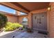 Inviting front entrance with beautiful brickwork, a decorative window, and lush, colorful landscaping at 3131 E Las Rocas Dr, Phoenix, AZ 85028