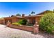 Well-maintained front yard of a single-story brick home, highlighted by lush shrubs at 3131 E Las Rocas Dr, Phoenix, AZ 85028