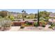 Beautiful single-story brick home with a well-manicured front yard and mature trees at 3131 E Las Rocas Dr, Phoenix, AZ 85028