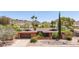 Charming single-Gathering brick home featuring a manicured front lawn and desert landscaping at 3131 E Las Rocas Dr, Phoenix, AZ 85028