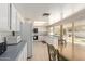 Bright eat-in kitchen with white appliances, tiled floor, and pool view at 3131 E Las Rocas Dr, Phoenix, AZ 85028