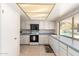 Functional kitchen featuring white cabinetry, grey countertops, and tile flooring at 3131 E Las Rocas Dr, Phoenix, AZ 85028