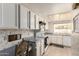 Bright kitchen showcasing white cabinets, tile floors, and a built-in desk space at 3131 E Las Rocas Dr, Phoenix, AZ 85028