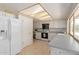 View of the eat-in kitchen featuring white appliances and a window at 3131 E Las Rocas Dr, Phoenix, AZ 85028