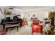Spacious living room with plush carpeting, piano, and antique furniture at 3131 E Las Rocas Dr, Phoenix, AZ 85028