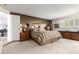 Serene primary bedroom featuring carpeted floors, mirrored walls and warm accents at 3131 E Las Rocas Dr, Phoenix, AZ 85028