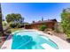 Backyard pool view showcasing mature trees, well-maintained landscaping, and the brick house at 3131 E Las Rocas Dr, Phoenix, AZ 85028