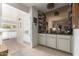 Cozy wet bar featuring mirrored backsplash, ample glassware storage, and carpeted floors at 3131 E Las Rocas Dr, Phoenix, AZ 85028