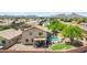 Aerial view of home with a sparkling in-ground pool, manicured lawn, covered patio, and desert landscaping at 32901 N Hidden Canyon Dr, San Tan Valley, AZ 85144