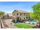 Aerial view of the home with a spacious backyard that features a pool, covered patio, and well-maintained landscaping at 32901 N Hidden Canyon Dr, San Tan Valley, AZ 85144