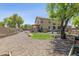 Expansive backyard featuring desert landscaping, pool, and covered patio at 32901 N Hidden Canyon Dr, San Tan Valley, AZ 85144