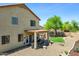 View of backyard with gravel, grassy area, covered patio, and desert landscaping at 32901 N Hidden Canyon Dr, San Tan Valley, AZ 85144