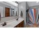 Dual sink bathroom with wood cabinets and a shower/tub with a stylish curtain at 32901 N Hidden Canyon Dr, San Tan Valley, AZ 85144