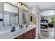 Bright bathroom features double sinks, granite counters and gold framed mirrors at 32901 N Hidden Canyon Dr, San Tan Valley, AZ 85144