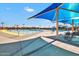 Community pool's shaded seating area, featuring comfortable chairs and a splash pad for  at 32901 N Hidden Canyon Dr, San Tan Valley, AZ 85144