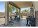 Inviting covered patio with outdoor seating and barbecue grill at 32901 N Hidden Canyon Dr, San Tan Valley, AZ 85144
