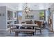 Bright dining room featuring contemporary light fixture, neutral tones, and wooden dining set at 32901 N Hidden Canyon Dr, San Tan Valley, AZ 85144