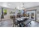 Open dining room featuring modern lighting, gray walls, and rustic wood accents around the french doors at 32901 N Hidden Canyon Dr, San Tan Valley, AZ 85144