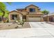 Inviting two-story home with desert landscaping, a two-car garage, and a basketball hoop on a sunny day at 32901 N Hidden Canyon Dr, San Tan Valley, AZ 85144