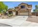 Inviting home featuring desert landscaping, a two-car garage, and a basketball hoop at 32901 N Hidden Canyon Dr, San Tan Valley, AZ 85144