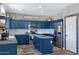 Bright kitchen with navy cabinets, a center island, stainless steel appliances, and pantry at 32901 N Hidden Canyon Dr, San Tan Valley, AZ 85144