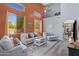 Bright living room with a soaring ceiling, many windows, modern furnishings, and stylish decor at 32901 N Hidden Canyon Dr, San Tan Valley, AZ 85144