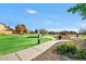 Scenic park with picnic areas, a playground, walking path, and mature landscaping at 32901 N Hidden Canyon Dr, San Tan Valley, AZ 85144