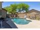 Private backyard pool with a desert landscape and fire pit at 32901 N Hidden Canyon Dr, San Tan Valley, AZ 85144
