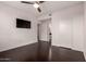 Bedroom featuring a ceiling fan, TV, dark wood floors and ensuite bathroom at 3302 N 7Th St # 344, Phoenix, AZ 85014