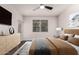 This bedroom has a ceiling fan, large window, and decorative lighting at 3302 N 7Th St # 344, Phoenix, AZ 85014