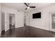 This bedroom has hardwood floors, a ceiling fan, TV and ensuite bathroom at 3302 N 7Th St # 344, Phoenix, AZ 85014