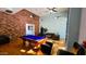 Billiards room with a pool table, seating area, and brick accent wall at 3302 N 7Th St # 344, Phoenix, AZ 85014