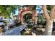 A community clubhouse entrance with rock landscaping, lush trees, and a fountain at 3302 N 7Th St # 344, Phoenix, AZ 85014